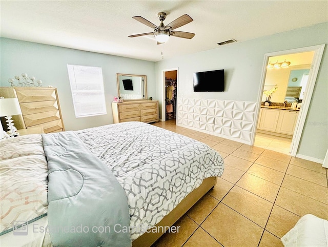 467 Martigues Dr, Kissimmee, FL 34759 - bedroom featuring tile patterned flooring, a spacious closet, a closet, a ceiling fan, and ensuite bath