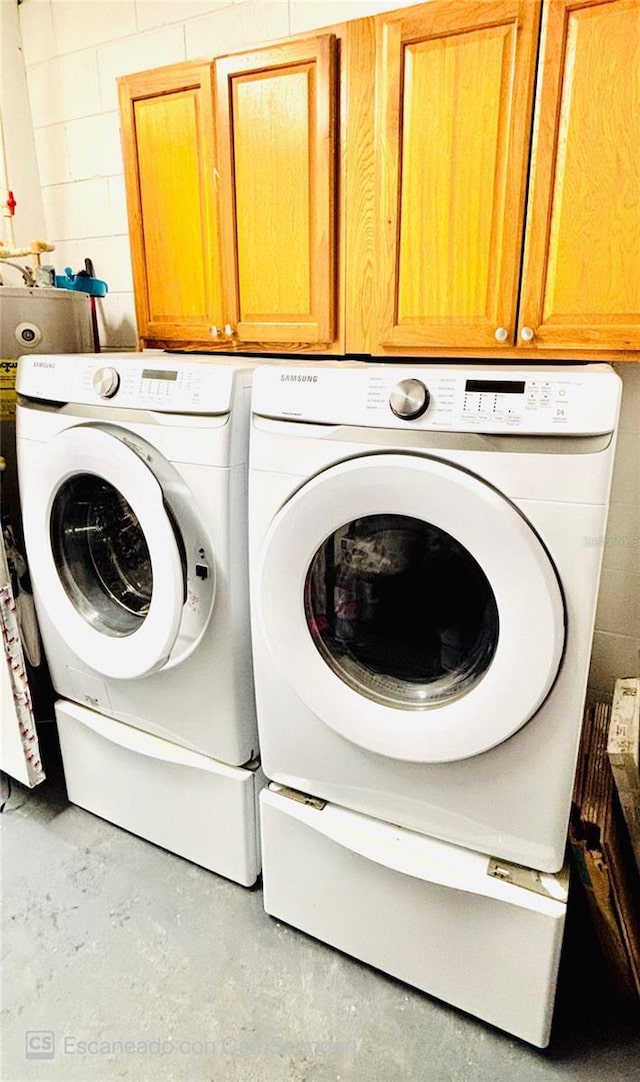 467 Martigues Dr, Kissimmee, FL 34759 - washroom with cabinet space, washing machine and dryer, and concrete block wall