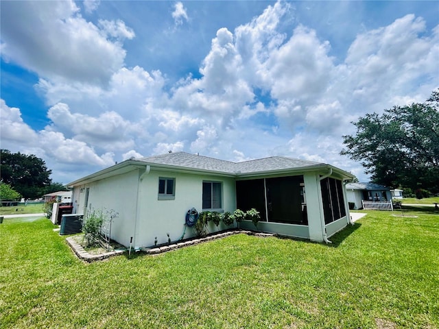 10237 SW 63rd Ave, Ocala, FL 34476 - rear view of house featuring a sunroom, a yard, and stucco siding