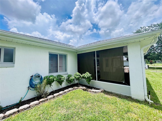 10237 SW 63rd Ave, Ocala, FL 34476 - view of side of property featuring a sunroom, a lawn, and stucco siding