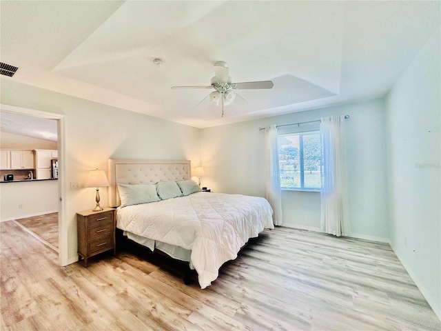 10237 SW 63rd Ave, Ocala, FL 34476 - bedroom with a tray ceiling, light wood finished floors, and ceiling fan