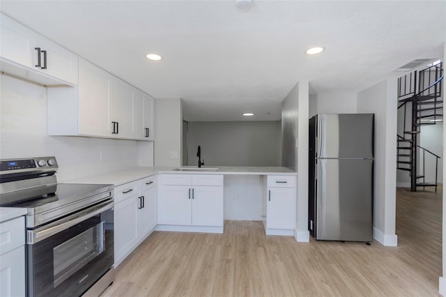 5151 Puritan Cir Unit 1022, Tampa, FL 33617 - kitchen with appliances with stainless steel finishes, a sink, light wood finished floors, light countertops, and recessed lighting