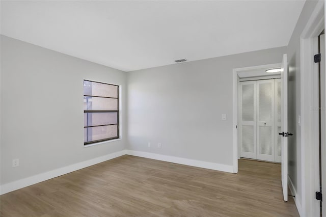 5151 Puritan Cir Unit 1022, Tampa, FL 33617 - unfurnished bedroom featuring wood finished floors and baseboards