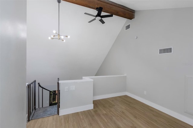 5151 Puritan Cir Unit 1022, Tampa, FL 33617 - empty room featuring wood finished floors, ceiling fan, a chandelier, and baseboards