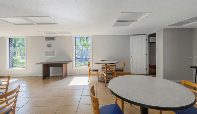 5151 Puritan Cir Unit 1022, Tampa, FL 33617 - dining area featuring a textured ceiling, attic access, light tile patterned floors, and baseboards