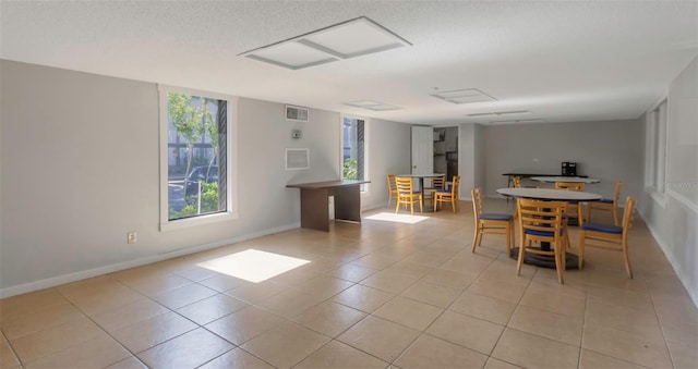 5151 Puritan Cir Unit 1022, Tampa, FL 33617 - dining space featuring light tile patterned floors, baseboards, and a textured ceiling