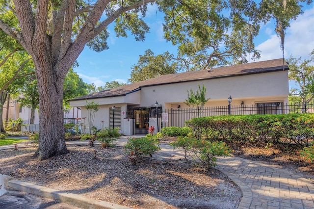 5151 Puritan Cir Unit 1022, Tampa, FL 33617 - view of front of home with stucco siding and a fenced front yard