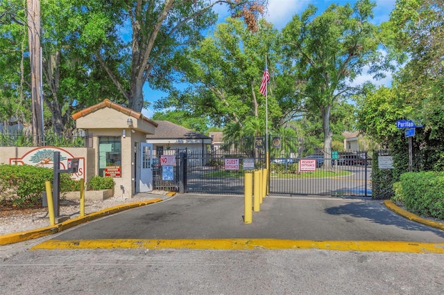 5151 Puritan Cir Unit 1022, Tampa, FL 33617 - view of asphalt street with a gate, a gated entry, and curbs