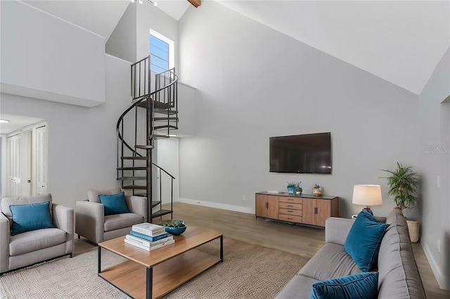 5151 Puritan Cir Unit 1022, Tampa, FL 33617 - living area with high vaulted ceiling, wood finished floors, stairs, and baseboards