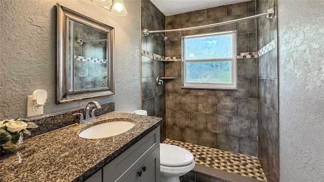 4218 Drexel Ave, Orlando, FL 32808 - full bathroom featuring a textured wall, vanity, and tiled shower