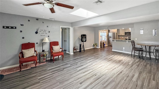 4218 Drexel Ave, Orlando, FL 32808 - living area featuring ceiling fan, a skylight, and wood finished floors