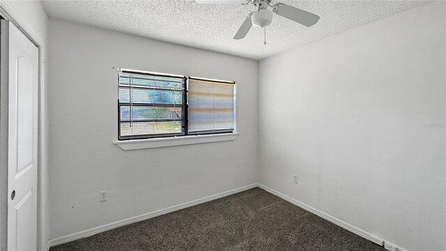4218 Drexel Ave, Orlando, FL 32808 - spare room featuring dark carpet, a textured ceiling, and ceiling fan