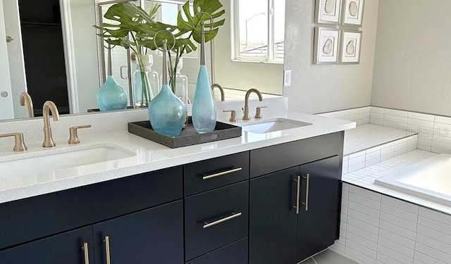 bathroom featuring double vanity and a relaxing tiled tub