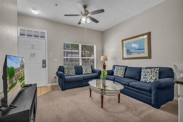 2614 Lodi Cir Unit 106, Kissimmee, FL 34746 - living room featuring carpet floors, a ceiling fan, a textured wall, and baseboards