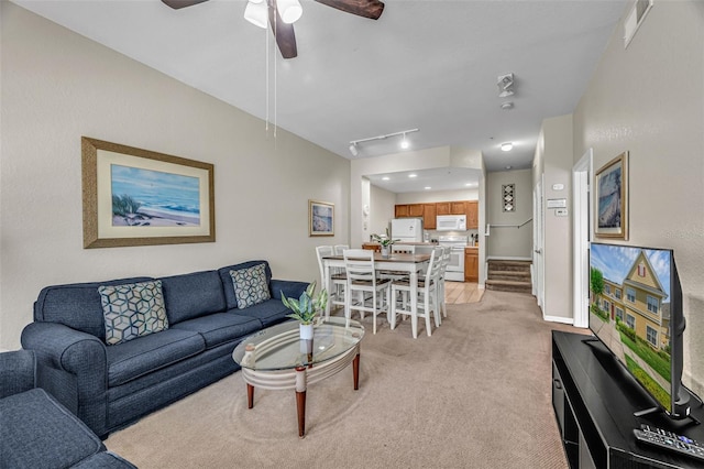 2614 Lodi Cir Unit 106, Kissimmee, FL 34746 - living room with light colored carpet, attic access, ceiling fan, baseboards, and track lighting