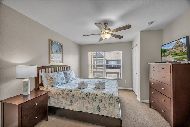 2614 Lodi Cir Unit 106, Kissimmee, FL 34746 - bedroom featuring light carpet, baseboards, a ceiling fan, and a closet