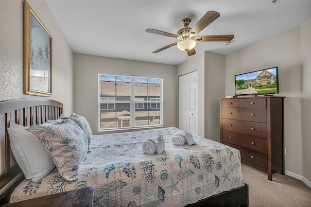 2614 Lodi Cir Unit 106, Kissimmee, FL 34746 - bedroom with light carpet, a ceiling fan, baseboards, and a closet