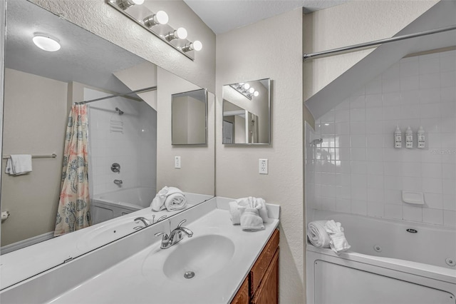 2614 Lodi Cir Unit 106, Kissimmee, FL 34746 - bathroom featuring a combined bath / shower with jetted tub, vanity, and a textured wall