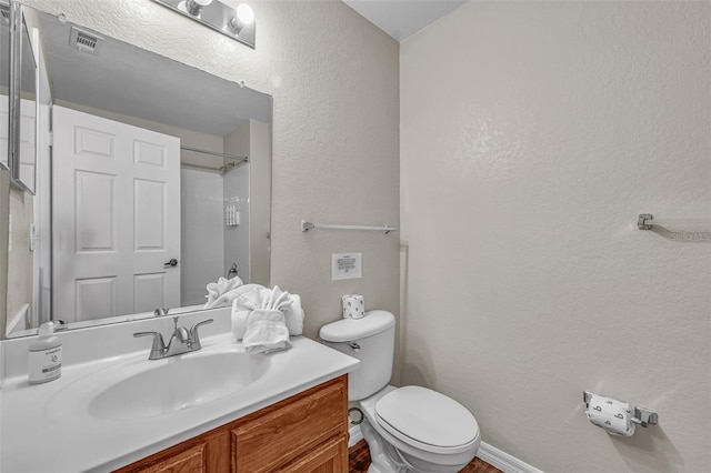 2614 Lodi Cir Unit 106, Kissimmee, FL 34746 - bathroom with toilet, a textured wall, a shower, and vanity