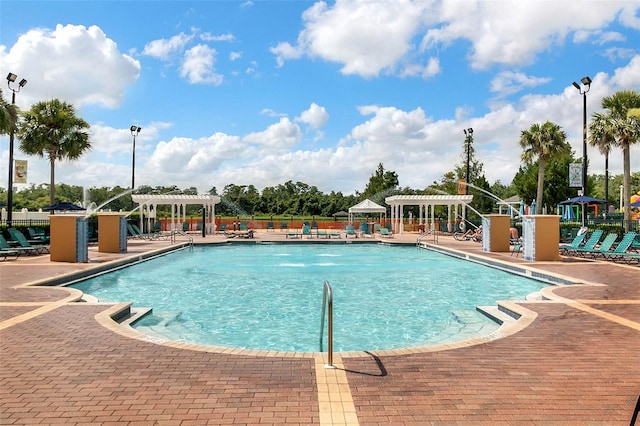 2614 Lodi Cir Unit 106, Kissimmee, FL 34746 - community pool with a pergola, a patio area, and fence
