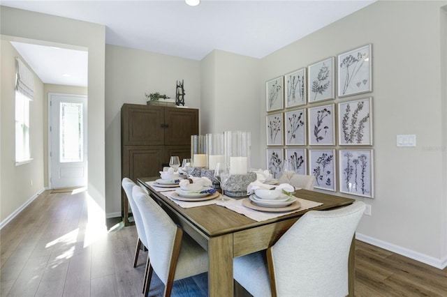 dining area featuring wood finished floors, baseboards, and recessed lighting