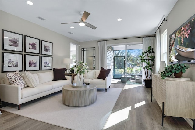 living room with ceiling fan, wood finished floors, and recessed lighting