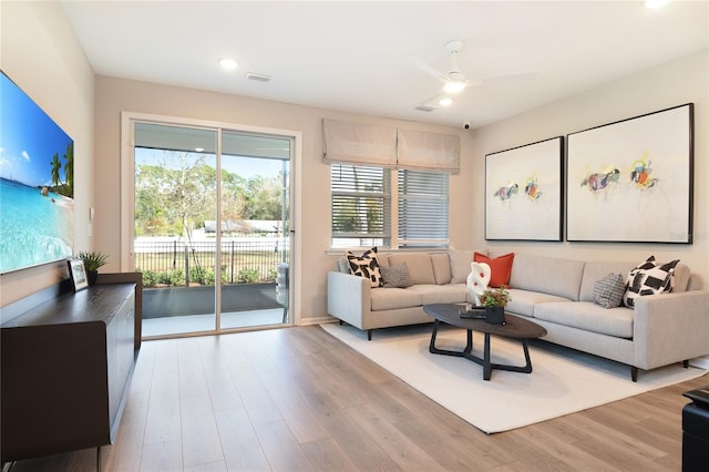 living area featuring wood finished floors, ceiling fan, and recessed lighting