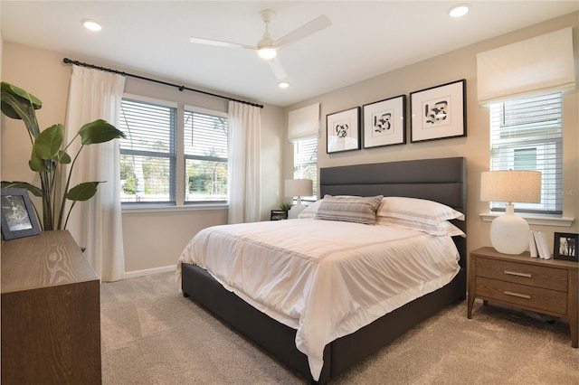 bedroom with light colored carpet, baseboards, recessed lighting, and a ceiling fan