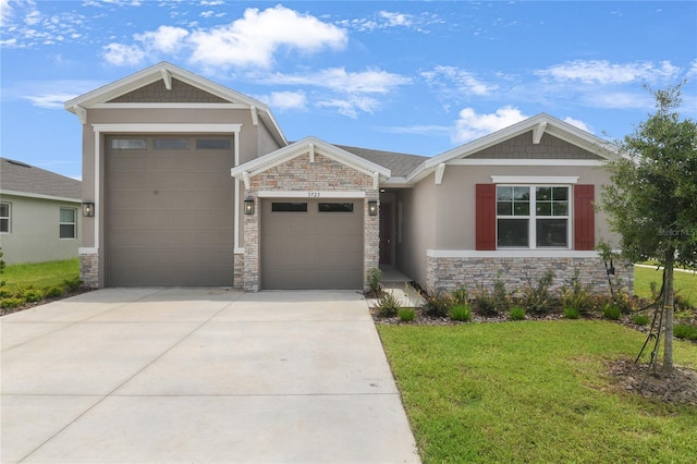 3723 Malad Way, Tavares, FL 32778 - view of front facade featuring stone siding, driveway, an attached garage, a front yard, and stucco siding