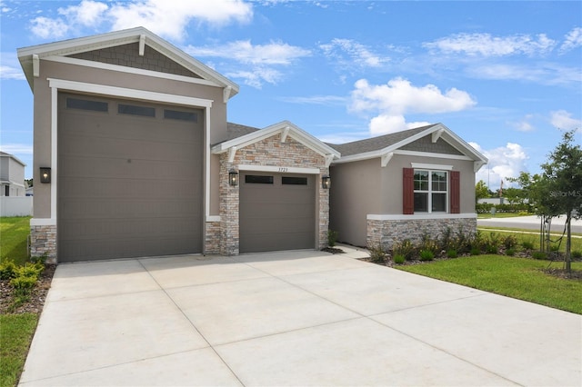 3723 Malad Way, Tavares, FL 32778 - craftsman-style home with stone siding, an attached garage, stucco siding, and driveway