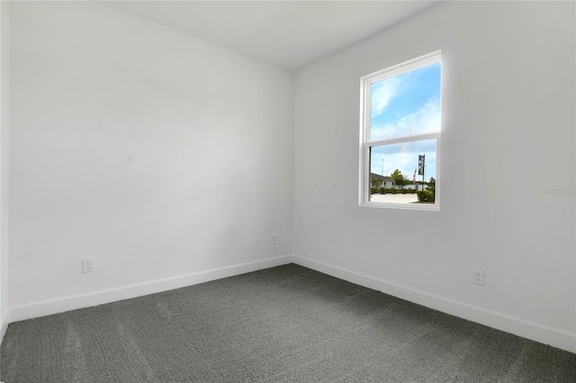 3723 Malad Way, Tavares, FL 32778 - spare room featuring dark carpet and healthy amount of natural light