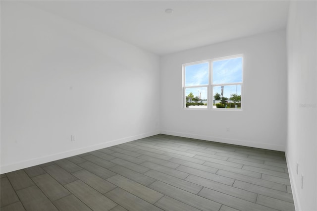 3723 Malad Way, Tavares, FL 32778 - empty room featuring dark wood-style floors and baseboards