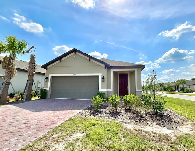 1001 Umbria Dr, Poinciana, FL 34759 - ranch-style house with stucco siding, decorative driveway, and a garage