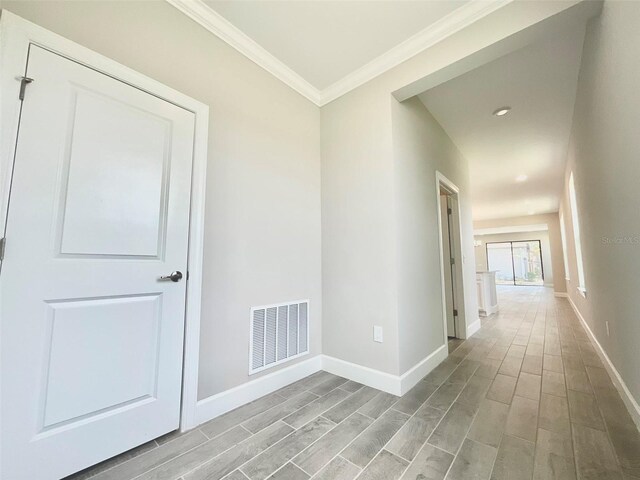 1001 Umbria Dr, Poinciana, FL 34759 - hallway with light wood-style flooring, ornamental molding, and recessed lighting