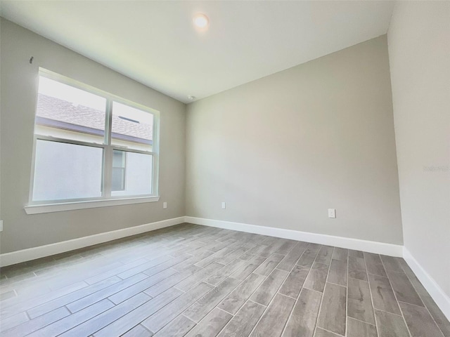 1001 Umbria Dr, Poinciana, FL 34759 - empty room featuring wood finished floors and baseboards