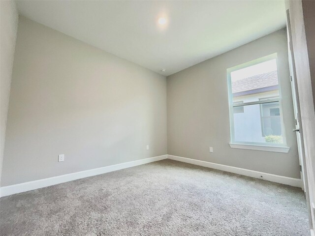 1001 Umbria Dr, Poinciana, FL 34759 - carpeted empty room with baseboards