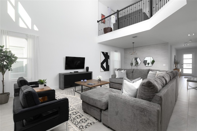 4290 Paragraph Dr, Kissimmee, FL 34746 - living room featuring a towering ceiling, baseboards, and tile patterned floors