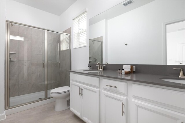 4290 Paragraph Dr, Kissimmee, FL 34746 - full bath featuring double vanity, a stall shower, and toilet