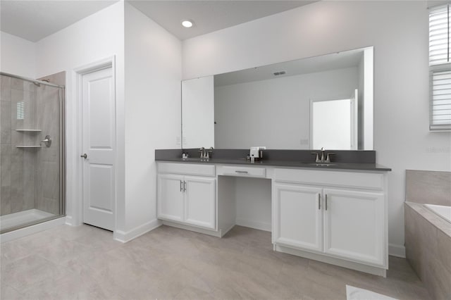 4290 Paragraph Dr, Kissimmee, FL 34746 - bathroom featuring double vanity, a stall shower, a bath, and tile patterned flooring