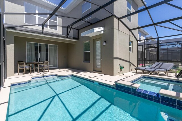 4290 Paragraph Dr, Kissimmee, FL 34746 - view of swimming pool featuring a patio area, glass enclosure, and a pool with connected hot tub
