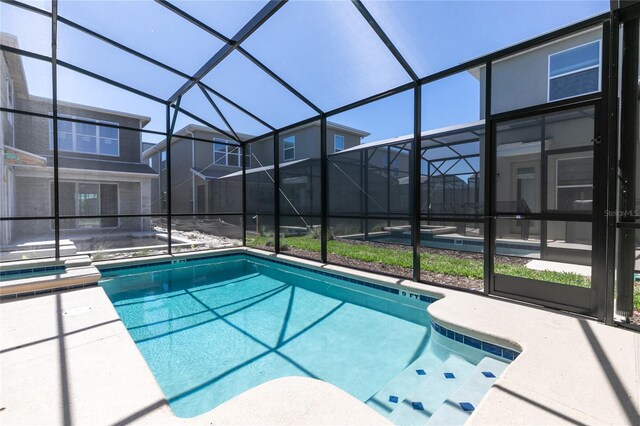 4290 Paragraph Dr, Kissimmee, FL 34746 - outdoor pool with a patio area, glass enclosure, and an outdoor hot tub
