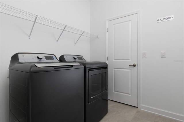 4290 Paragraph Dr, Kissimmee, FL 34746 - washroom with washer and dryer and baseboards