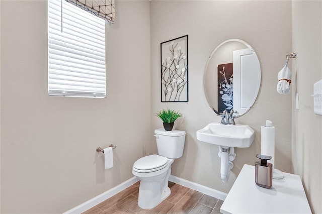 9253 Players Dr, Weeki Wachee, FL 34613 - half bath with toilet, wood finish floors, baseboards, and a sink
