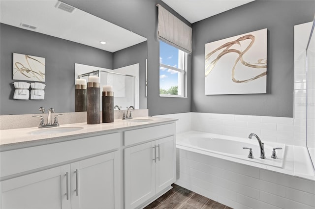 9253 Players Dr, Weeki Wachee, FL 34613 - full bath featuring a bath, double vanity, and wood finished floors