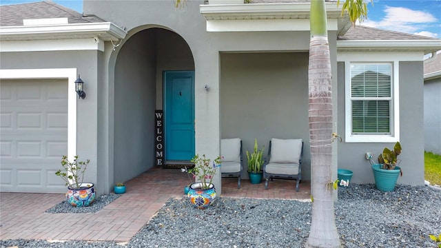 140 Trinity Ridge Cir, Davenport, FL 33897 - doorway to property featuring stucco siding, an attached garage, and a shingled roof