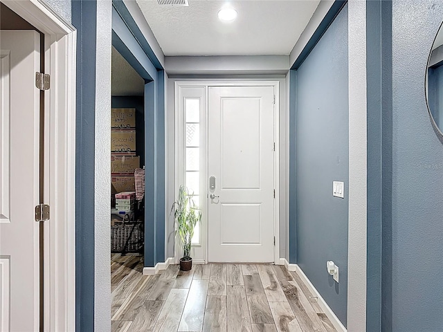 140 Trinity Ridge Cir, Davenport, FL 33897 - entryway featuring light wood-style floors and baseboards