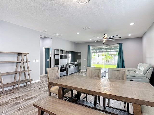 140 Trinity Ridge Cir, Davenport, FL 33897 - dining area featuring a ceiling fan, light wood-style flooring, recessed lighting, baseboards, and a textured ceiling