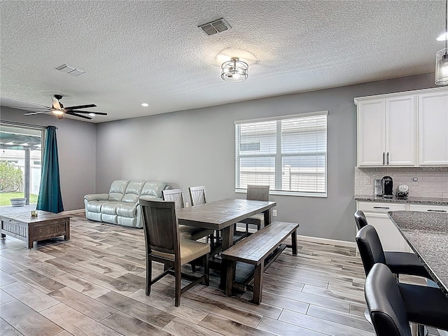 140 Trinity Ridge Cir, Davenport, FL 33897 - dining room featuring wood finish floors, ceiling fan, recessed lighting, and a textured ceiling