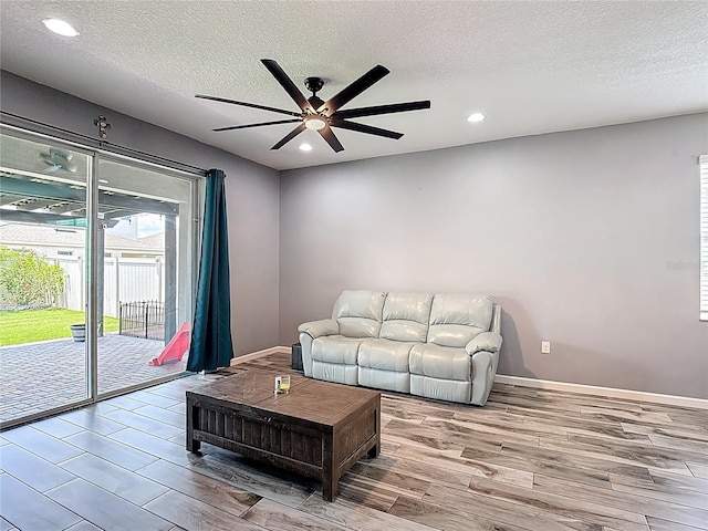 140 Trinity Ridge Cir, Davenport, FL 33897 - living room featuring ceiling fan, wood finished floors, a textured ceiling, recessed lighting, and baseboards