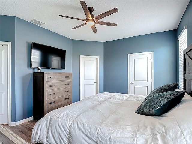 140 Trinity Ridge Cir, Davenport, FL 33897 - bedroom with wood finished floors, baseboards, a textured ceiling, and a ceiling fan
